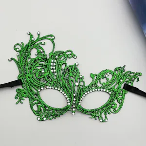 Detailed closeup of the exquisite green lace masquerade mask featuring sparkling rhinestones.