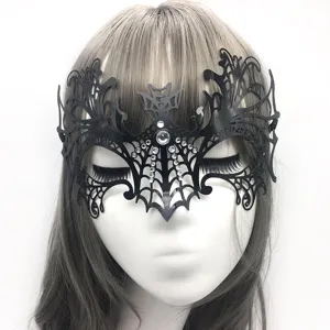 Close-up detail of the black metal hollow-out half-face bat mask with sparkling rhinestones.