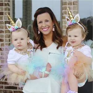 Detailed scene view of children unicorn headband and party outfit worn by cute babies.