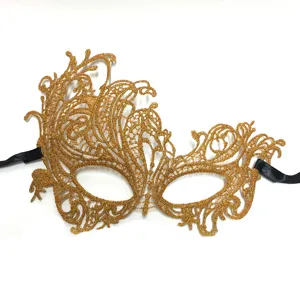 Gold lace masquerade mask detail view, delicate hollow out lace pattern with black ribbons.
