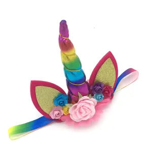Detailed view of kids unicorn party headband with rainbow horn and golden glitter ears.