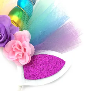 Unicorn birthday party headband detail shot featuring colorful tulle and sparkly ears.
