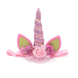 Detailed view of kids pink unicorn headband with glitter horn, floral decor and soft elastic band.