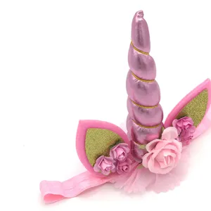 Cute pink unicorn headband with glitter ears and flowers for kids birthday party accessories.
