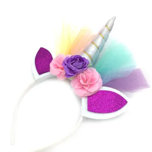 Cute unicorn headband with silver horn, colorful tulle and flowers for party show.