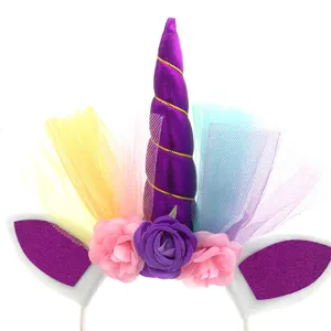 Unicorn birthday party hair hoop with purple horn, colorful tulle and flower decorations.
