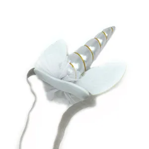 Unicorn headband detail shot, featuring silver horn, white felt ears, and soft elastic band.