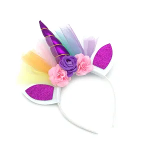 Close-up of unicorn party headband with purple horn, colorful tulle, and glitter ears.