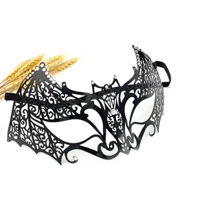 Black metal bat mask detail showing exquisite laser cut patterns and shimmering rhinestones.