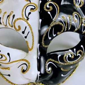 Exquisite black and white masquerade mask with gold glitter details, perfect for Halloween.