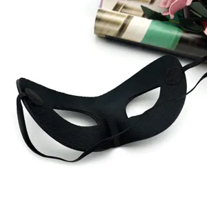 Close-up detail of the black textured half-face masquerade mask with elastic strap and fine finish.