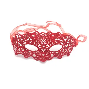 Red lace mask detail shot, delicate cutout pattern, elegant masquerade party costume prop.