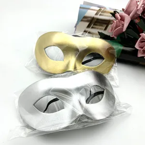 Detailed view of gold and silver masquerade masks in clear packaging, perfect for party dress up.