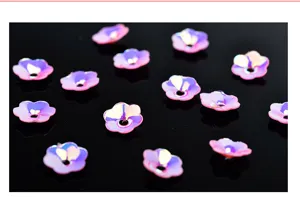Close-up detail of 6mm pink iridescent flower sequins, cupped bead caps for DIY crafts and garment accessories.