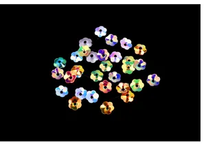 Close-up detail of 6mm iridescent flower sequins, center hole DIY craft material.