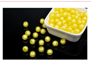 Yellow acrylic loose beads detail showing translucent bead-in-bead design for DIY handmade jewelry.