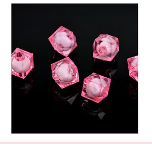 Close-up detail of pink acrylic beads in beads, clear transparent square craft accessory for DIY.