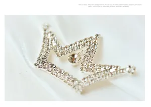 Detailed shot of a sparkling rhinestone crown hair accessory, elegant bridal hair piece.