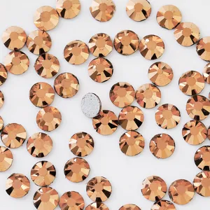 Close-up detail of copper color flatback glass rhinestones for DIY nail art and phone decor.