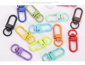 Colorful metal spring keychains, vibrant rotating lobster clasps and hooks for bags and DIY crafts.