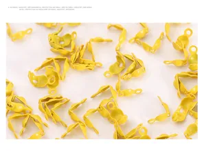 Close up of yellow clamshell bead tips, metal jewelry findings for DIY bracelet necklace ends.