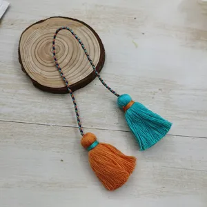 Close-up detail of the dual-color cotton tassel with braided hanging cord for Hanfu.