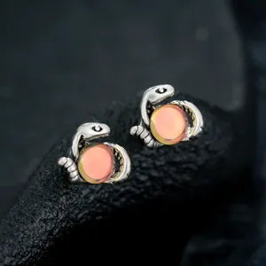Snake ear clips detail shot featuring magical glowing orange orb design for personalized fashion jewelry.