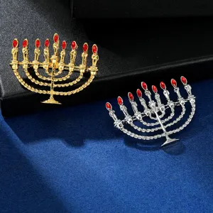 Exquisite menorah shape brooch detail featuring metallic finish and vibrant red crystal stones.
