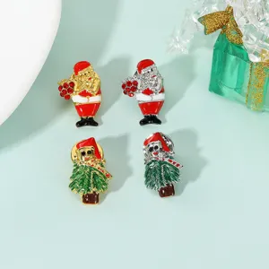 Christmas brooch set featuring Santa Claus and tree designs with sparkling rhinestone details.