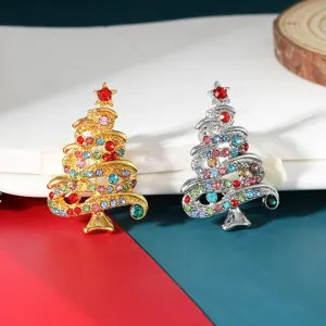 Detailed close-up of rhinestone Christmas tree brooch pins in gold and silver colors.
