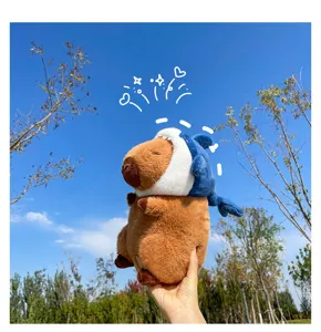 Capybara plush toy with cute blue shark hat, soft stuffed animal doll for kids gift details.