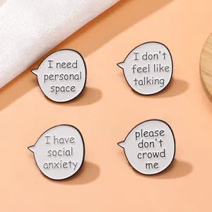 Cute enamel chat bubble brooch pin with English letter design, stylish fashion clothing accessory.