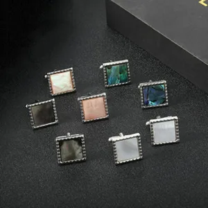 Detailed shot of square men's cufflinks with multi-color shell inlay for business shirts.