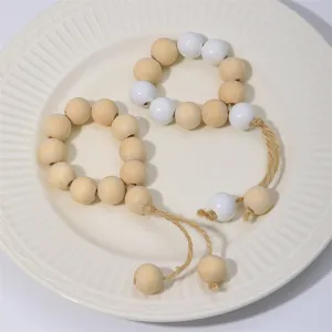 Wooden bead napkin ring detail showing natural wood and white beads with handmade hemp rope tassel.