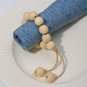 Handcrafted wooden bead napkin ring with tassel detail for table decor and dining setup.