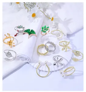 Detailed shot of various metal napkin rings featuring leaf, pearl, and Christmas designs.