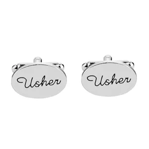 Silver metal oval cufflinks featuring custom text 'Usher', elegant suit shirt accessory.