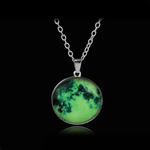Close-up detail of the glowing moon glass pendant necklace showing luminous green texture clearly.