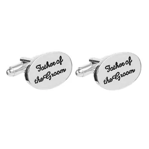 Silver tone oval metal cufflinks featuring engraved Father of the Groom text design.