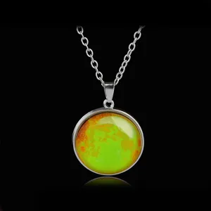 Close-up detail of the glowing starry sky pendant necklace with fine silver chain and luminous orb.