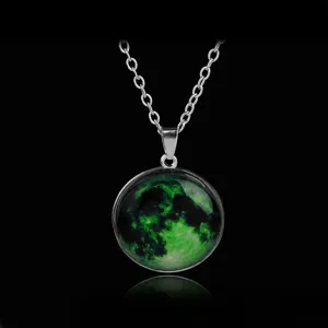 Close-up detail of the glowing green moon planet pendant necklace showing exquisite craftsmanship.