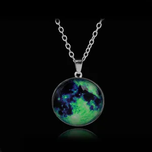Glowing moon glass pendant necklace detail showing luminous starry sky pattern and silver chain.
