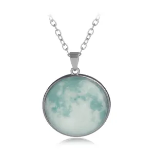 Luminescent moon glass pendant necklace detail shot, glowing night effect turquoise gemstone.