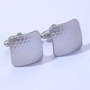 Close-up view of elegant silver square hammered cufflinks for men, professional business style.