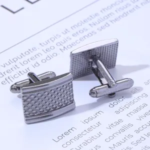 Detail shot of men's business metal cufflinks with textured square grid design in gunmetal.