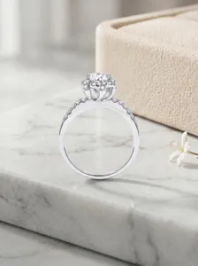 Detail view of the 925 sterling silver 1ct moissanite six-petal flower ring with pavé stones.