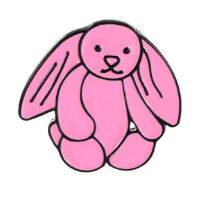 Detailed shot of cute pink bunny enamel pin, glossy metal brooch, kawaii rabbit accessory.