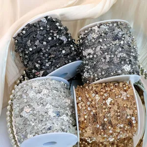 Detailed close-up of colorful DIY rhinestone butterfly chains on spools for jewelry making.