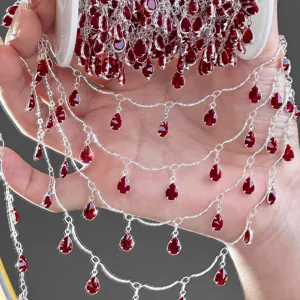 DIY silver tone metal chain with sparkling red teardrop zircon stones for jewelry making.