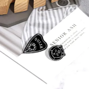 Gothic punk enamel pin set featuring ouija planchette and black cat pentagram designs.